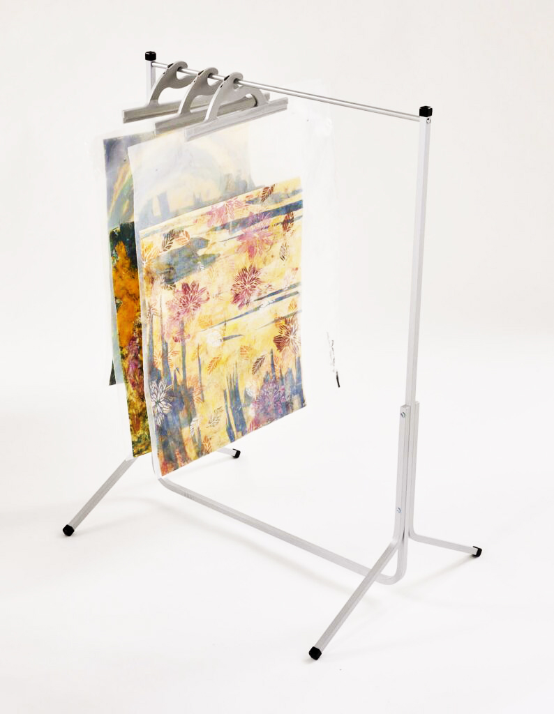 Anodized aluminum floor rack for hanging multi-use see-through poly storage bags – example bags hold artwork