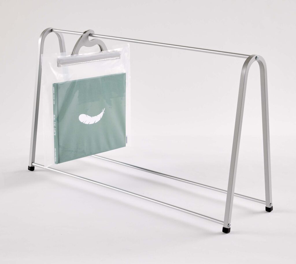 Anodized aluminum tabletop rack for hanging multi-use see-through poly bags – example bags hold books